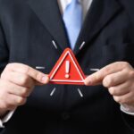 businessman crisis triangle sign